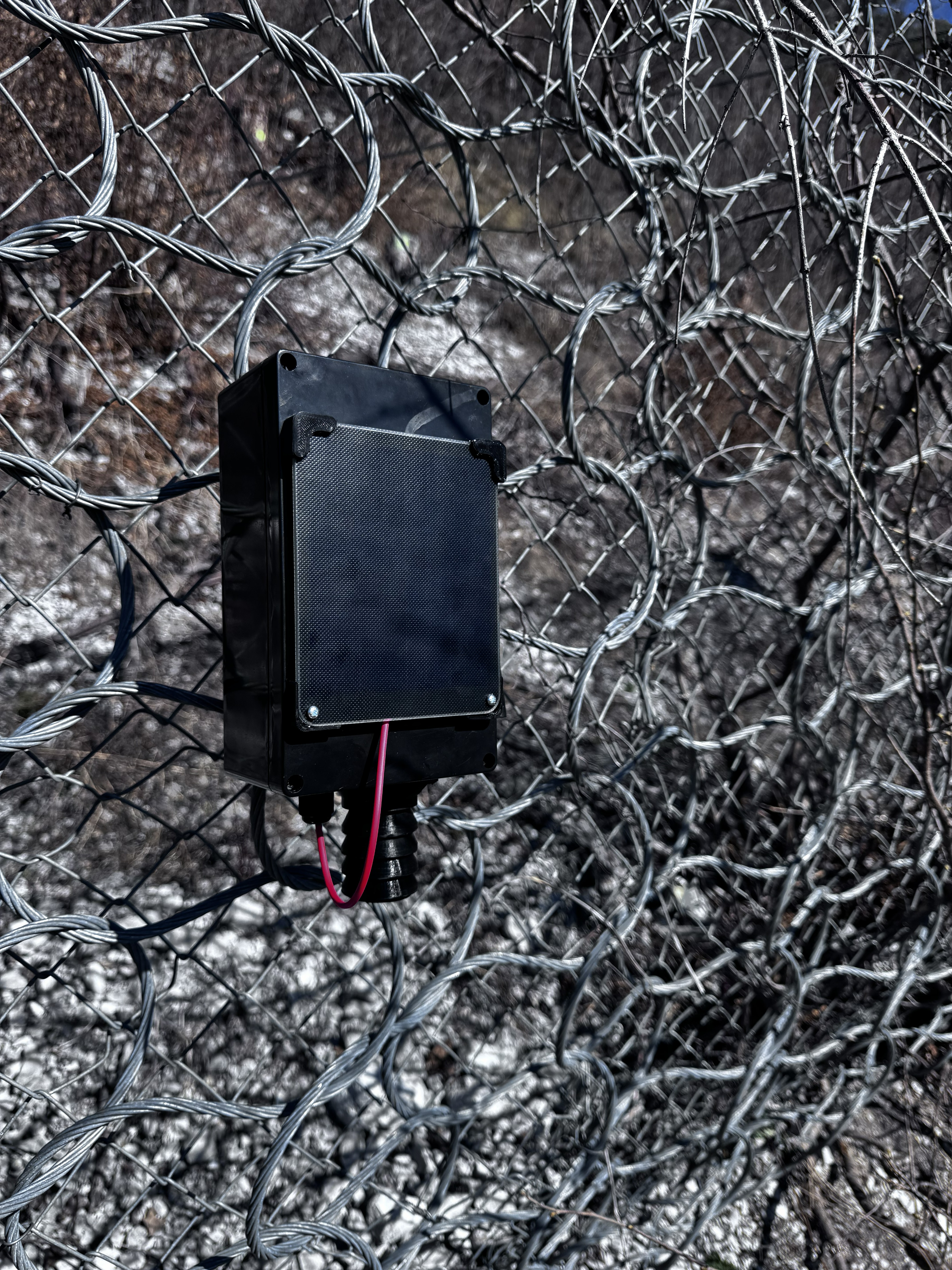 Self-powered sensor with solar panel on a rock face